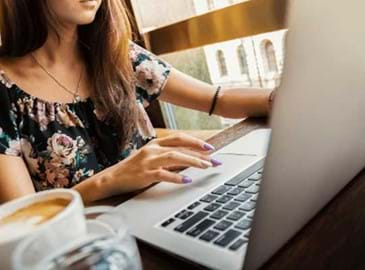 Woman taking payments on a laptop