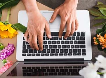 woman using social media on a laptop